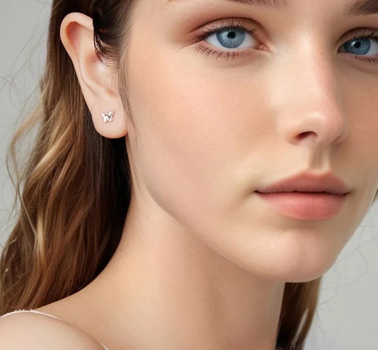 Pair of original S925 sterling silver butterfly stud earrings with shiny electroplated finish on white background
