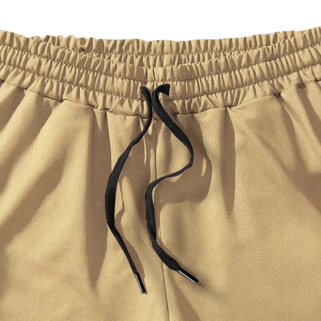 Men's casual khaki polyester sports shorts with coconut print on a model