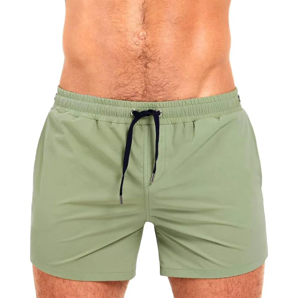 Men's solid colour polyester shorts with mesh lining for swimming and sports.