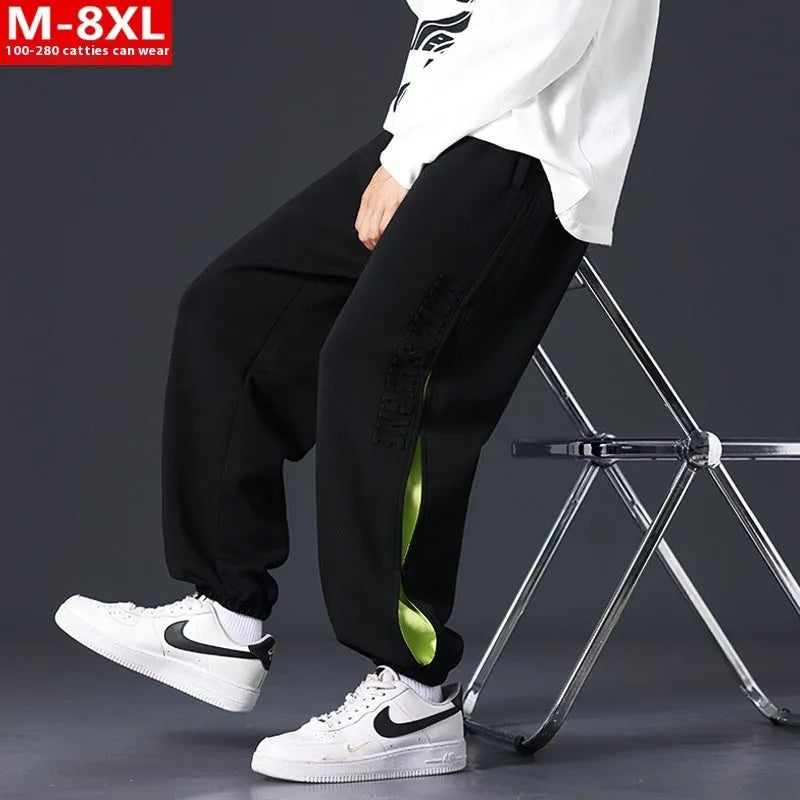 Men's loose-fit cotton trousers with printed stitching detail and ankle banding in grey green colour