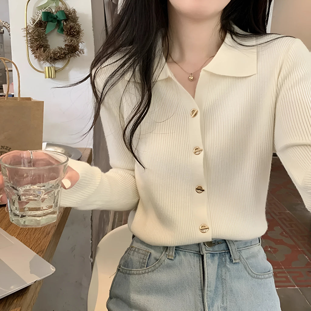 Long-sleeved beige viscose knit cardigan top shown on a hanger, demonstrating its loose fit and regular sleeve length.