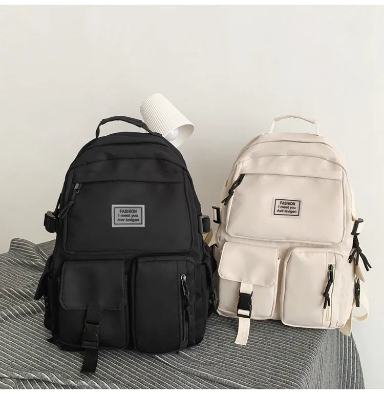 Black and white student nylon backpack with laptop compartment and outer pockets.