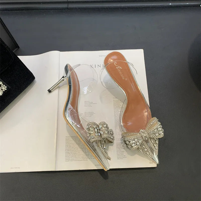Silver bow rhinestone pointed transparent slip-on high heel sandals with 6-8cm heel and rubber outsole