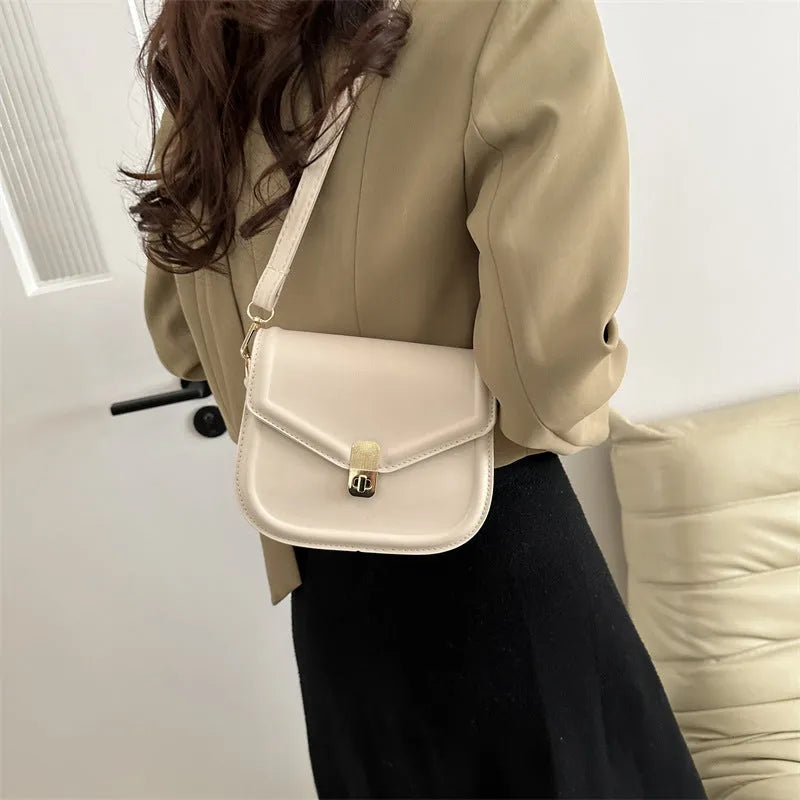Soft PU leather clamshell shoulder messenger bag in horizontal square shape.