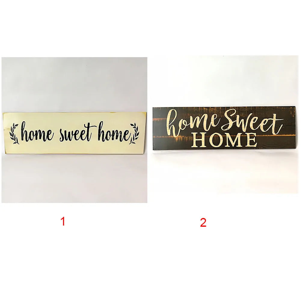 Wooden carved Home Sweet Home wall hanging ornament in black, 40cm long, 12cm high, on a white wall