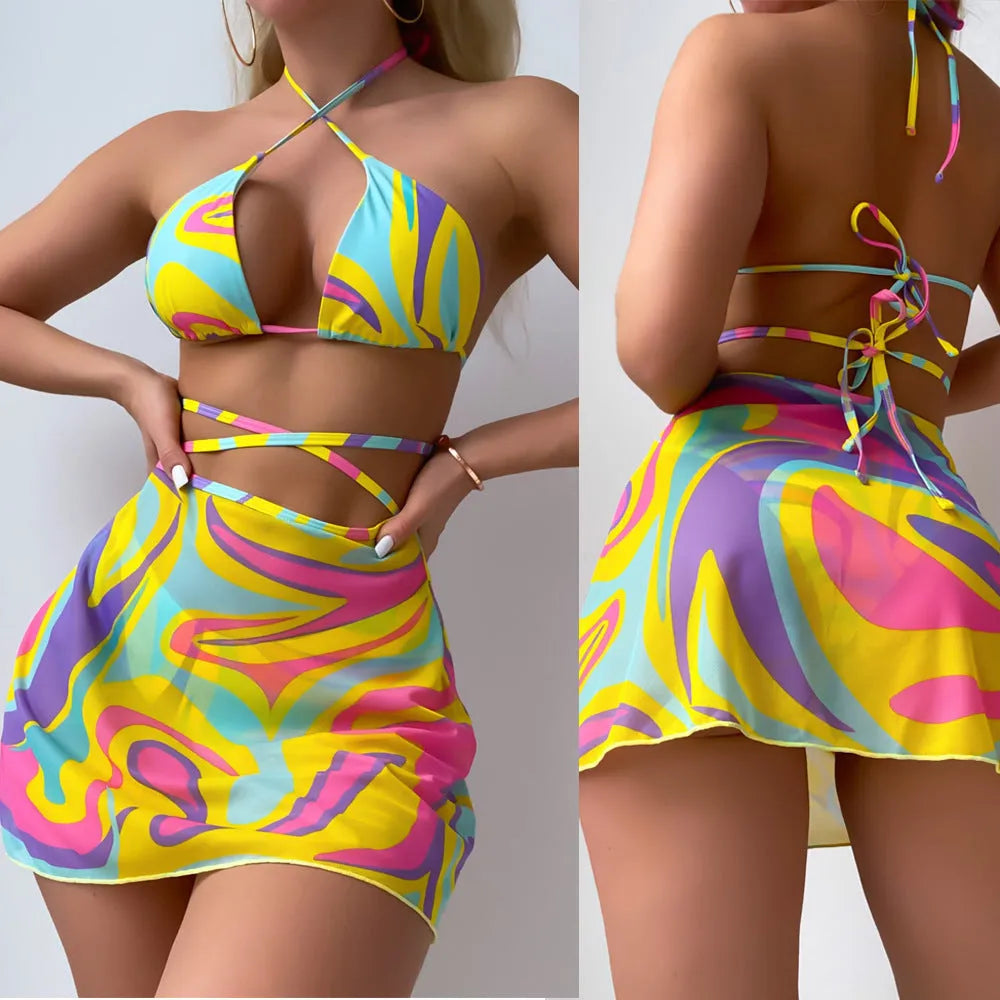 Women's yellow halter lace-up striped swimsuit set with top, skirt, and shorts on a model