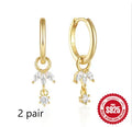 S925 sterling silver earrings with a geometric sunflower design and inlaid zircon stones in a golden colour.