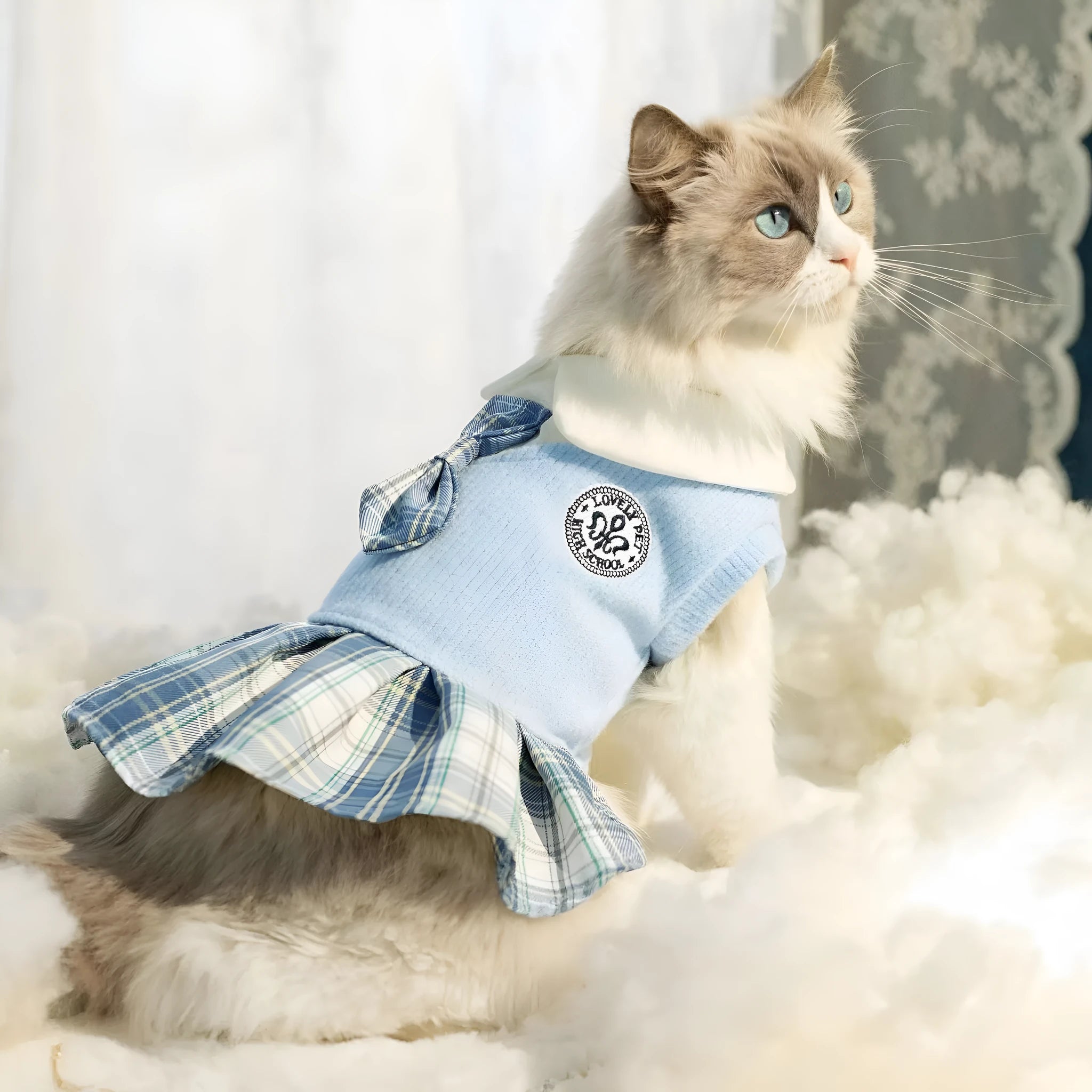 A pink tartan skirt for small dogs and cats with an adjustable velcro waist closure.