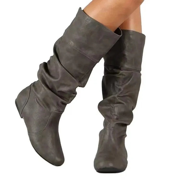 Women's black flat-heel slip-on long boots with a high shaft and round toe.
