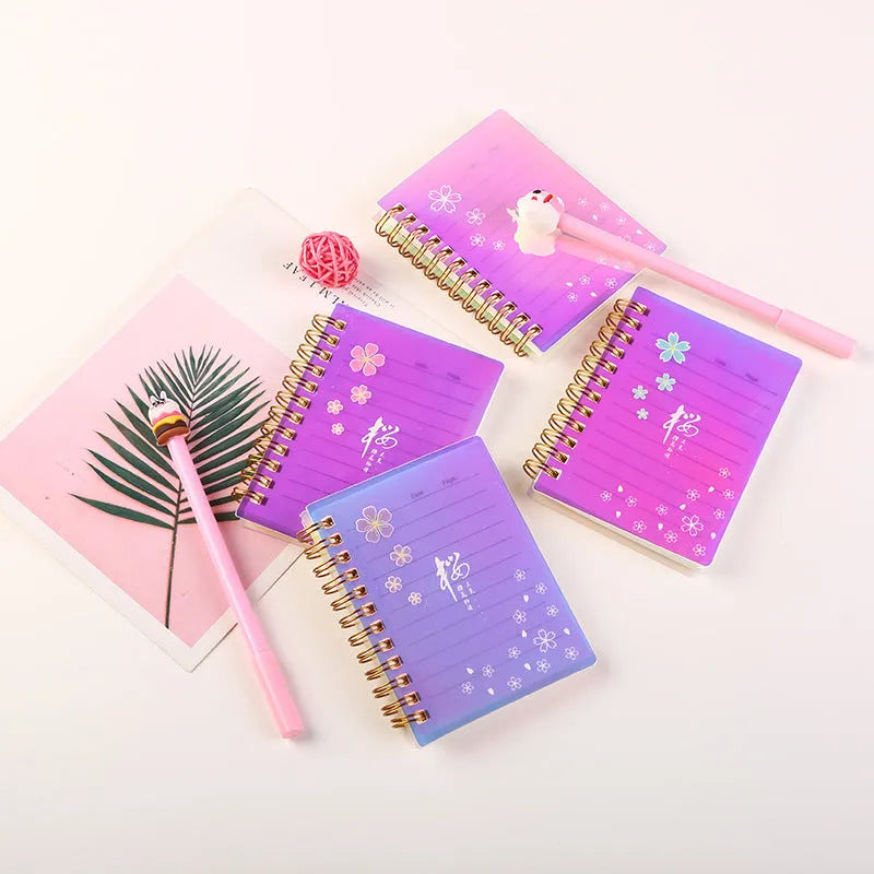 A7 spiral-bound pocket notebook with PP plastic cover in cherry blossom design showing open pages with 80g paper