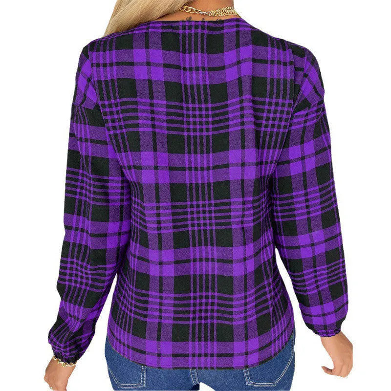 Woman wearing a loose-fitting purple plaid shirt with regular sleeves.