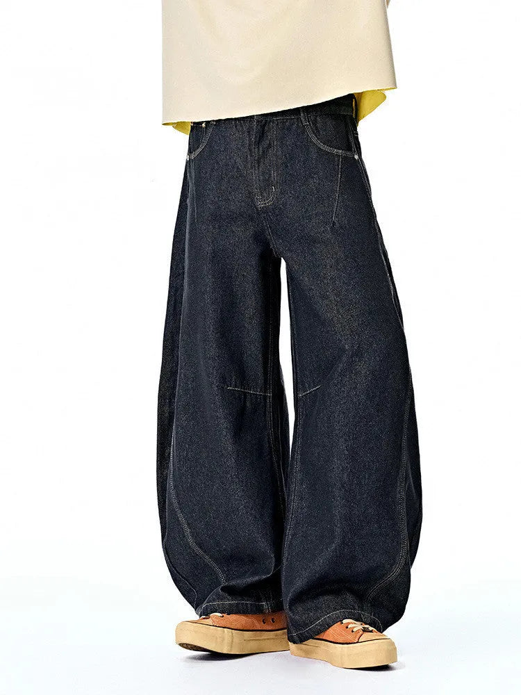 Men's wide leg cotton denim trousers in original cow colour, shown laid flat.