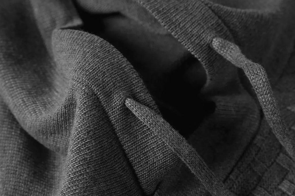 Men's black cotton polyester blend hooded sweater laid flat, showing the front design and hood.