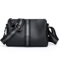 Black genuine leather crossbody bag showing front view with single shoulder strap
