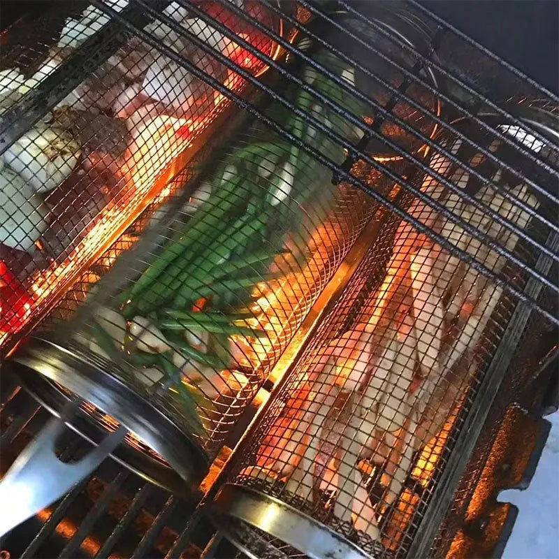 Rolling grill basket metal mesh cylinder with hooks on barbecue, containing vegetables and meat