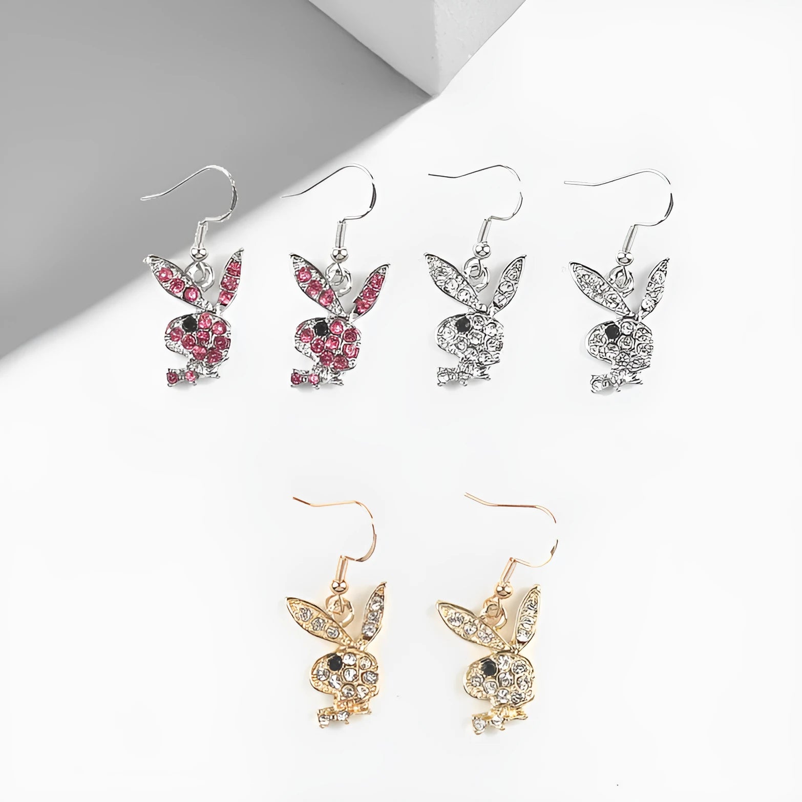 A pair of cute cartoon rabbit stud earrings for women in silver, pink, or gold colour.