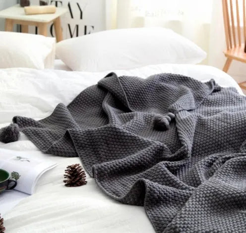 Acrylic knit ball blanket in beige colour, measuring 130 by 170 centimetres, laid flat.
