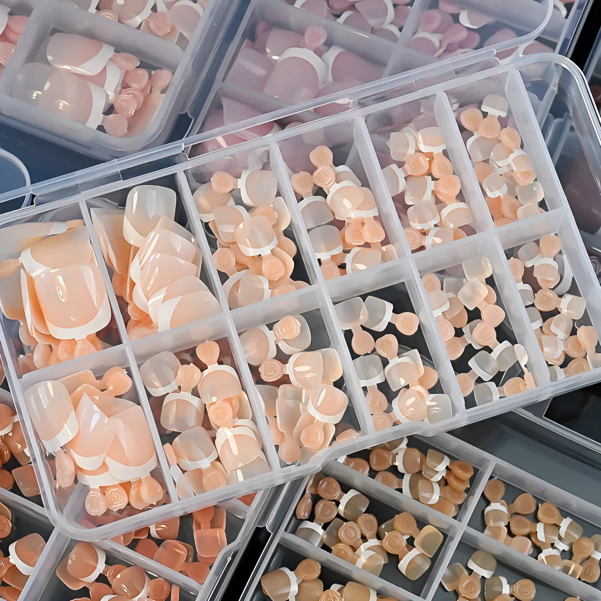 Open box showing 120 full square short French white edge toe nail tips in various nude shades.