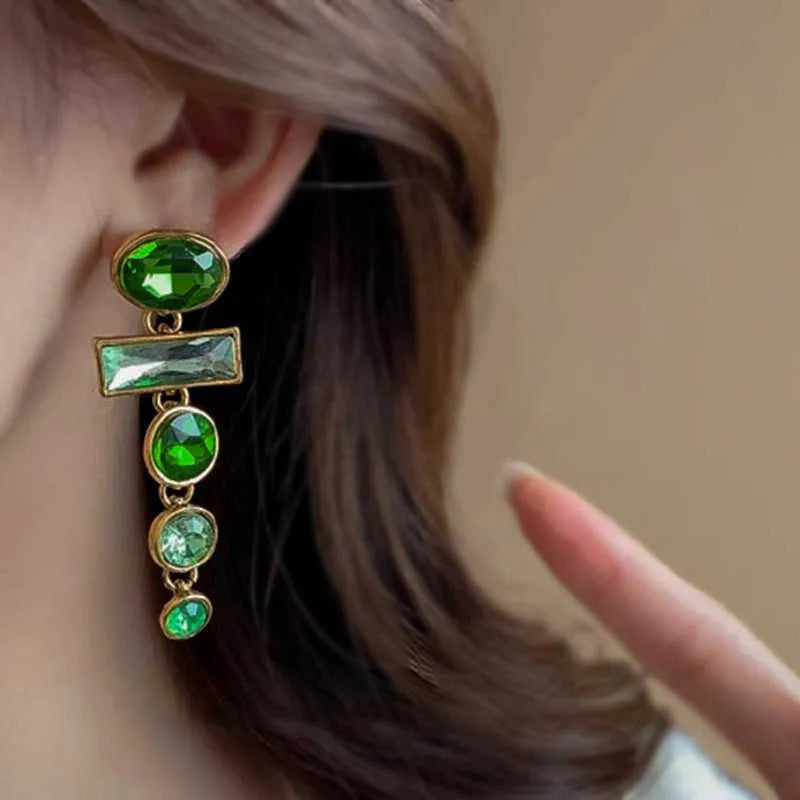 A pair of retro green gradient tassel earrings with inlaid zircon stones in a Chinese geometric style.