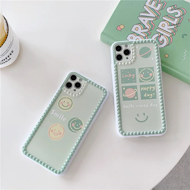 Green flexible TPU iPhone case with geometric smiley face and polka dot frame design.