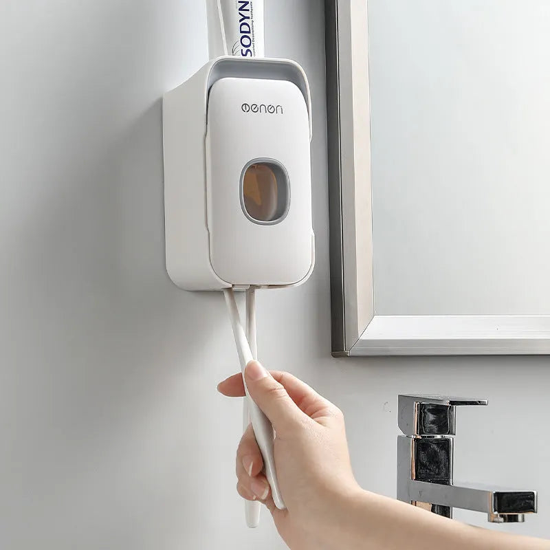 Automatic toothpaste dispenser unit in blue, grey, and pink colours made from ABS plastic.