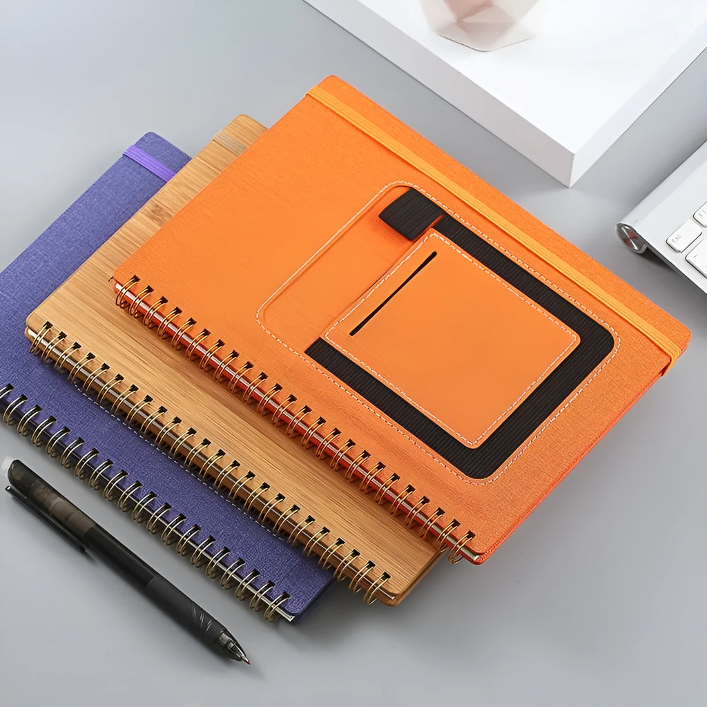Erasable spiral notebook with stone paper, pen, and cloth on a wooden table