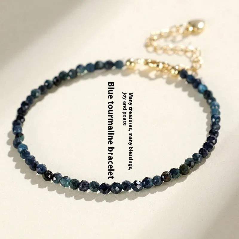 Close-up of a women's blue tourmaline bracelet with 3mm cut beads and spacer bead design.