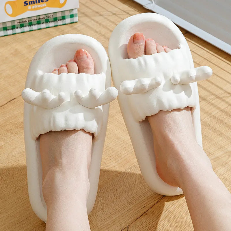 Women's light yellow EVA flip flop slippers with deer horn design and hollow-out upper on a plain background.