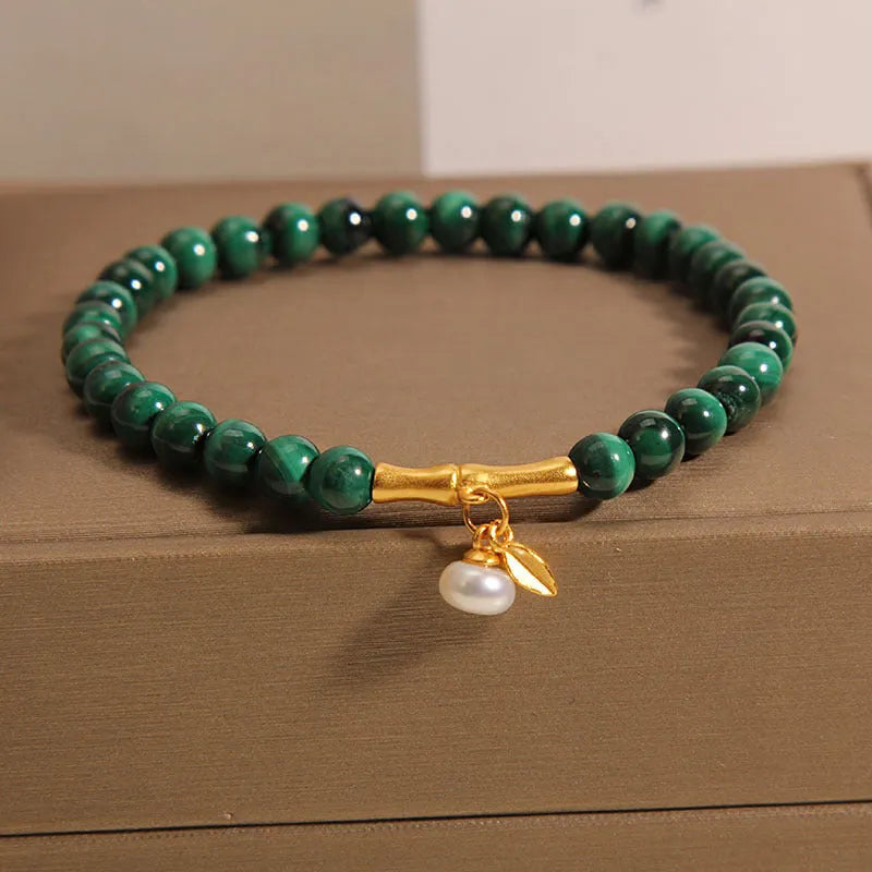 Women's white crystal lucky bamboo bracelet on display