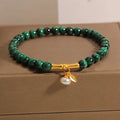 Women's white crystal lucky bamboo bracelet on display