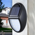 Black rectangular LED solar wall light for outdoor mounting with a solar panel on top.