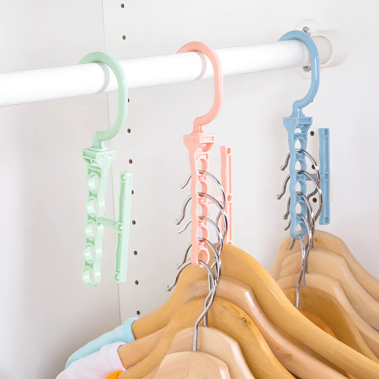 Magic wardrobe hanger with five holes and handle in blue, green, or pink colour options
