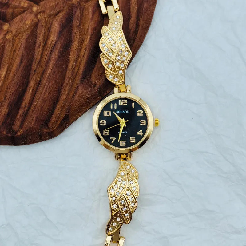 Stainless steel women's watch with round dial and vachette clasp, shown in gold, black, and white colour options.