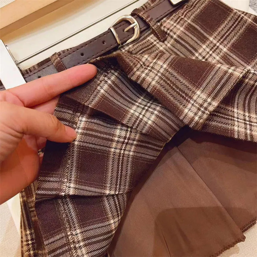 Girls plaid pleated A-line skirt in cotton blend, shown on hanger.