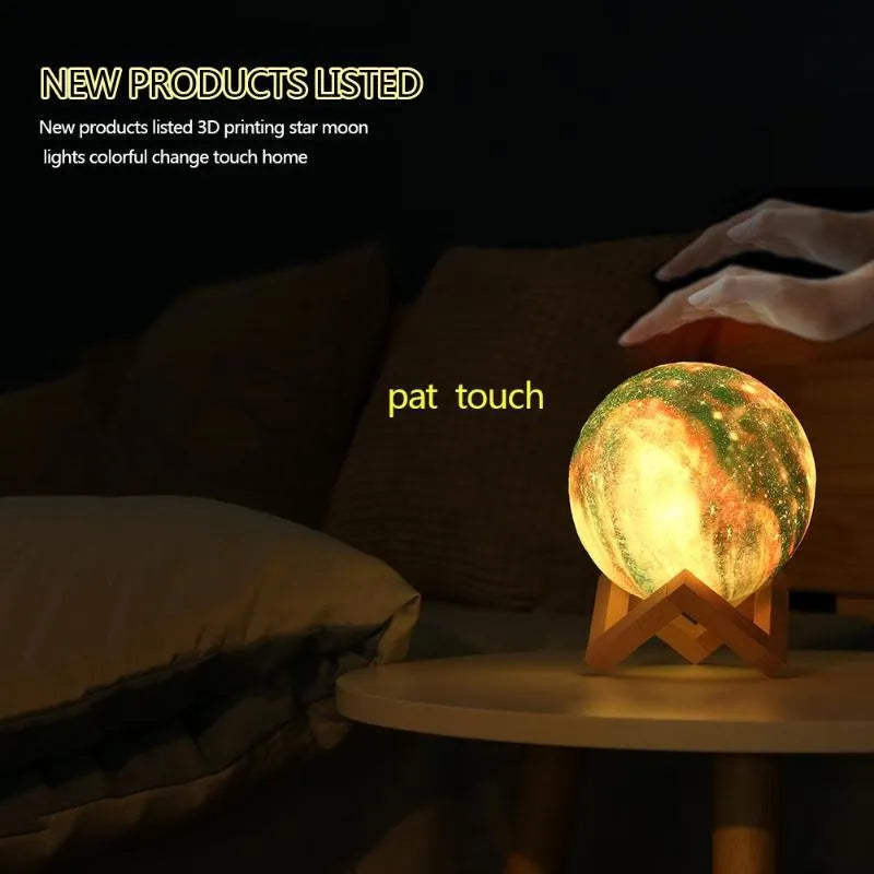 3D printed spherical lunar night light with multi-colour LED glow on a dark surface.
