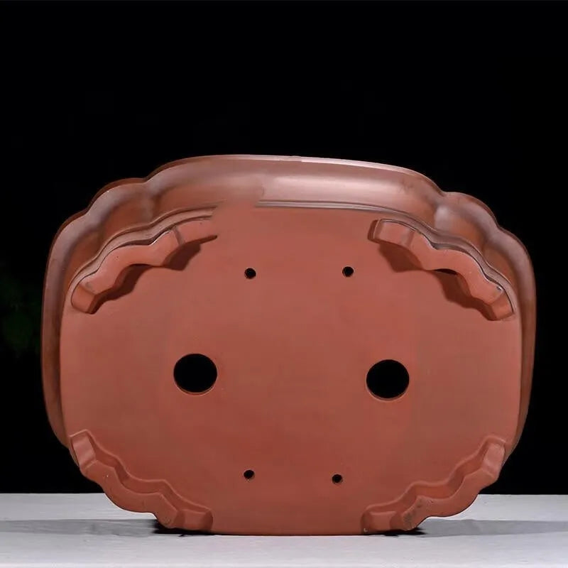 Large antique-style purple clay flowerpot with Chinese design for outdoor garden use.