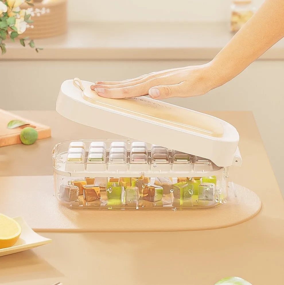 High capacity plastic ice cube tray with grid and removable ice shovel stored in its slot.
