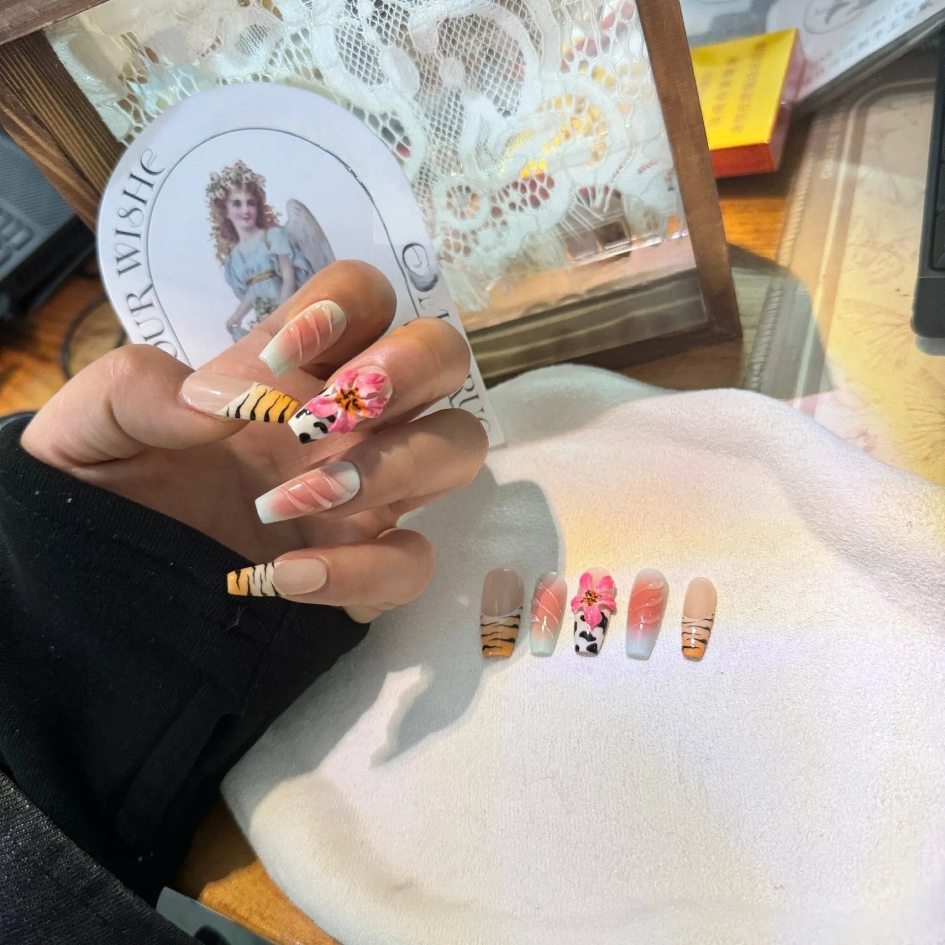 Lily hand carving acrylic nail art set featuring black and white zebra stripes with raised pink floral embossments.