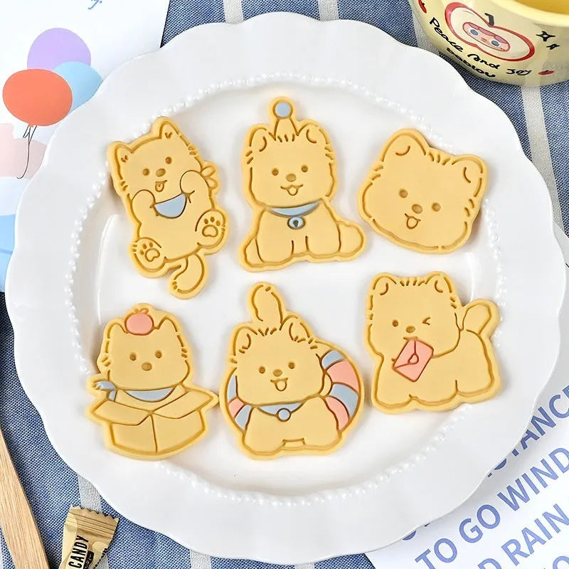 Three-dimensional plastic biscuit mould with cartoon puppy designs including birthday hat and swimming ring patterns