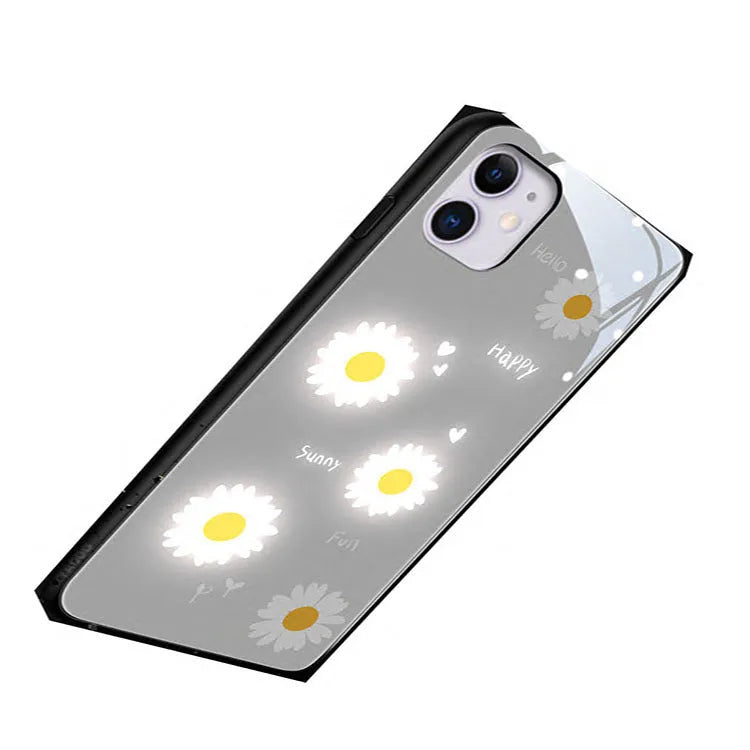 White TPU iPhone case with a painted purple daisy and letter design, showcasing its voice-activated luminous feature.