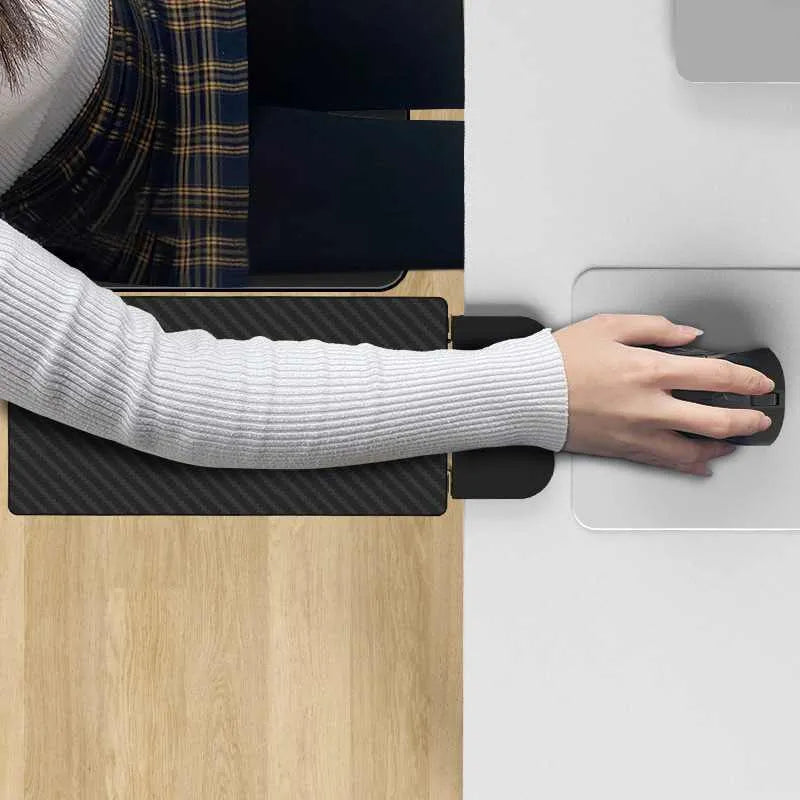 Ergonomic hand bracket in black carbon fiber veneer on a desk for arm support during computer use