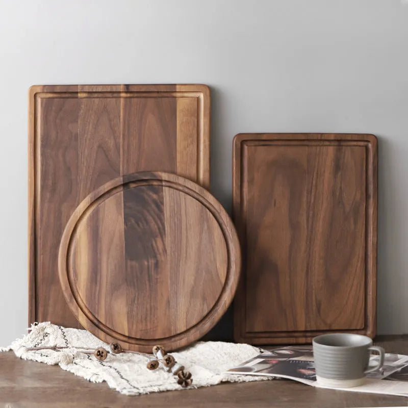 Black walnut wood cutting board with juice groove, dual-sided design, available in round and rectangular sizes for kitchen use