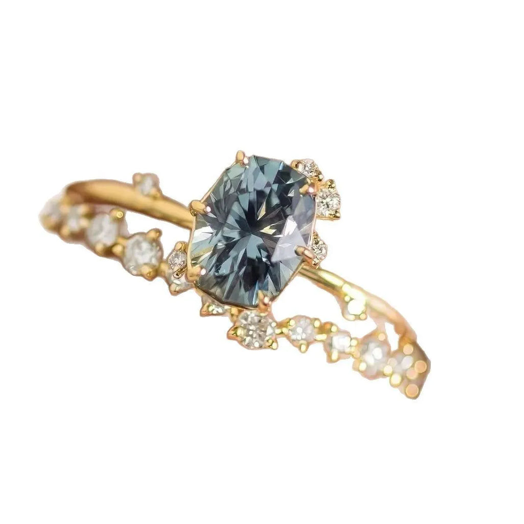 Gold plated floral-shaped women's ring with green zircon stones on an alloy band.