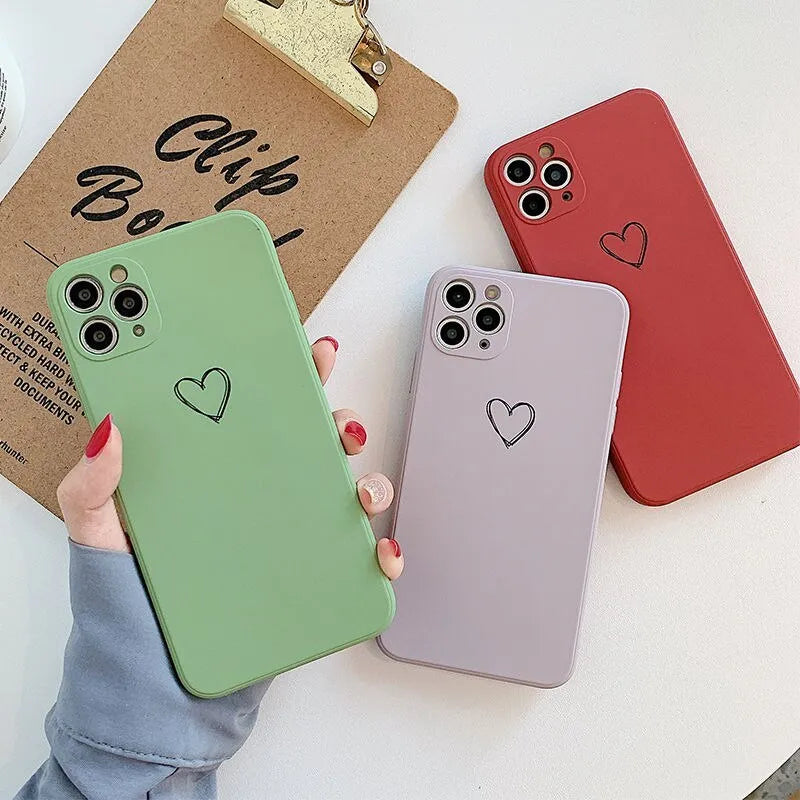 Solid colour silicone TPU back cover case for Apple iPhone on a table.