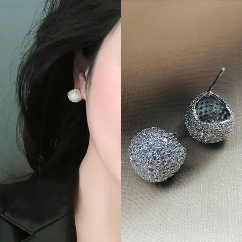 Gold and white geometric drop earrings with sphere elements and crystal embellishments