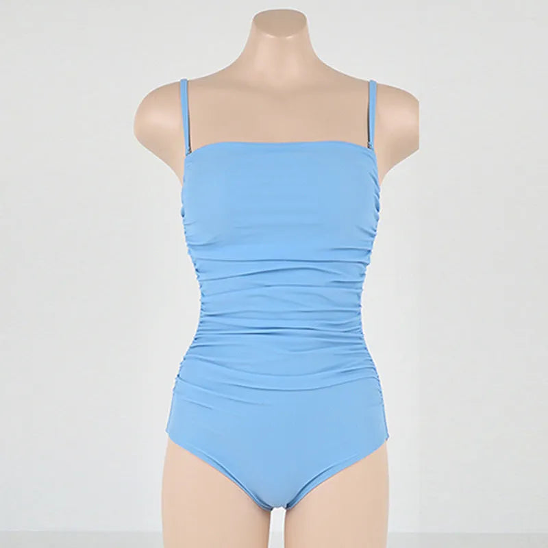Blue sling style one-piece swimsuit with belly pleats on a mannequin