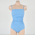 Blue sling style one-piece swimsuit with belly pleats on a mannequin
