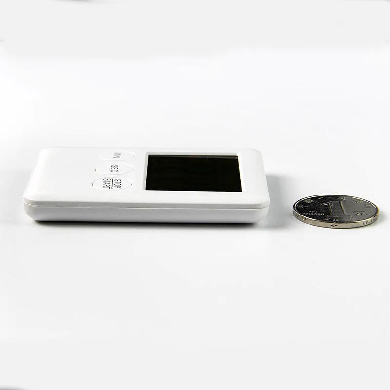 Mechanical kitchen timer with magnetic back showing white dial with black numbers