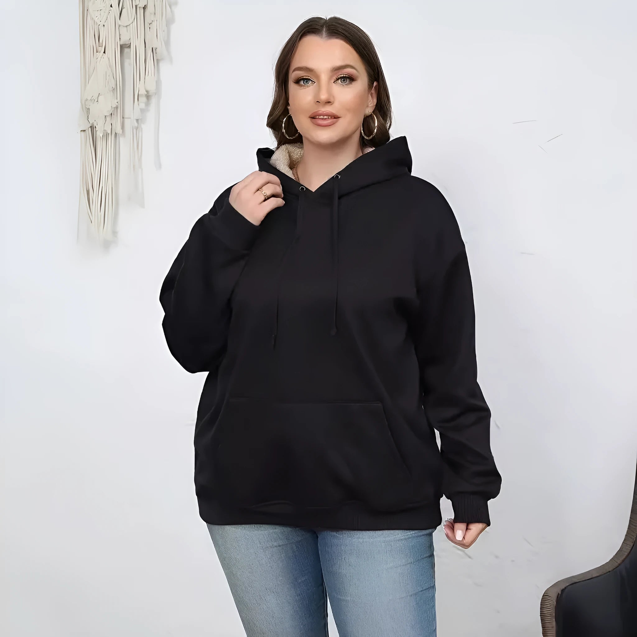 Women's loose-fit grey hooded sweater with a front pocket and a textured 3D pattern.
