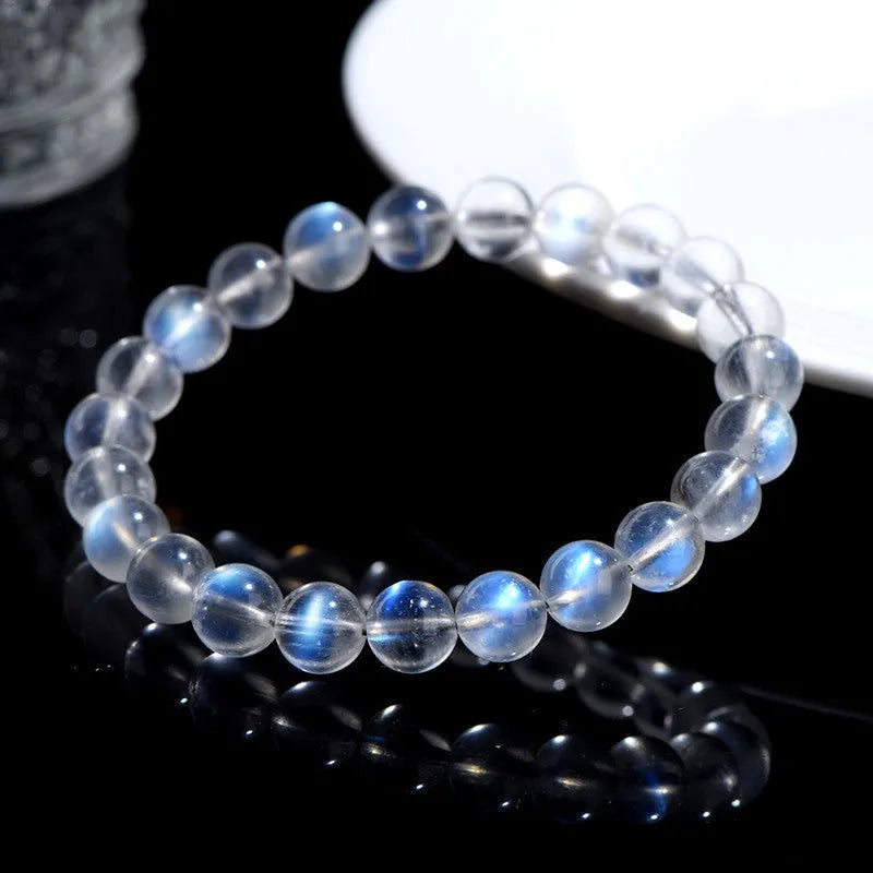 Natural cream body blue moonlight crystal bracelet on a plain background showing its size and style.